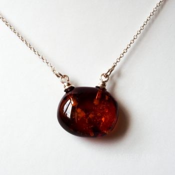 Brown Amber Pendant With A Silver Chain