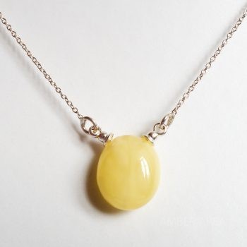 Yellow Polished Amber Pendant With A Silver Chain